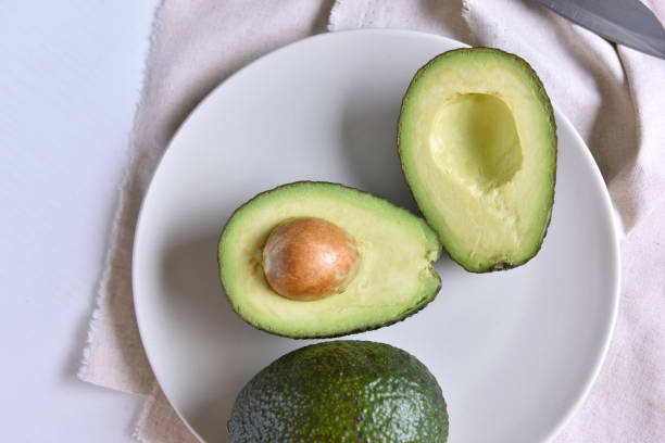 istock Fresh ripe avocado and slice on a plate. Top view. 861296472