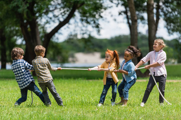 istock kids playing tug of war 861302896