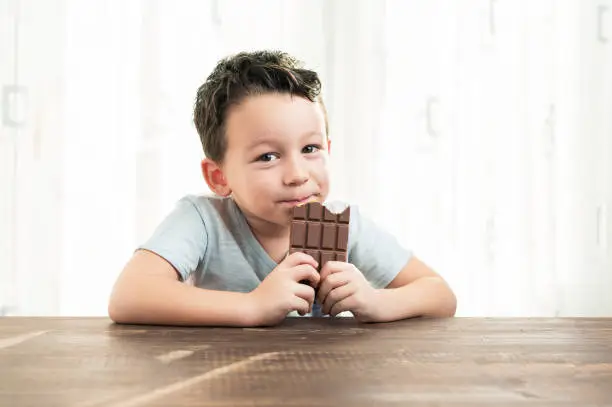 Photo of Child is eating chocolate.