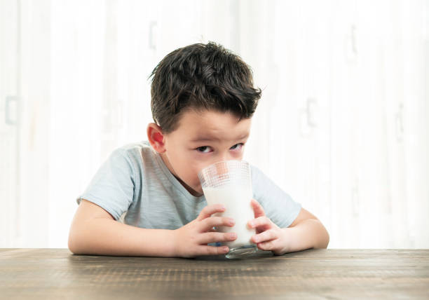 istock Child drinking a glass of milk. 861307272