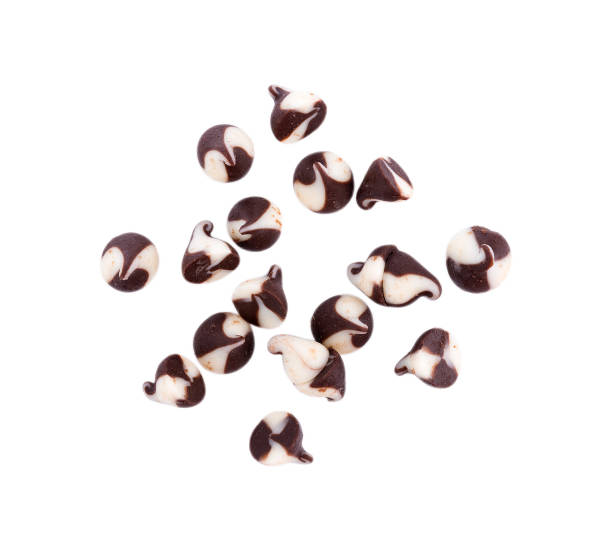 chocolate chip morsels spread on white background - choc chip imagens e fotografias de stock