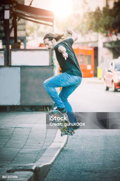 Pro Skater Doing Tricks And Jumps On Street Free Ride Stock Photo - Download Image Now