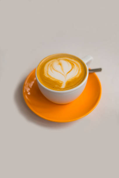 istock White and orange coffee cup with cappuccino 861325122