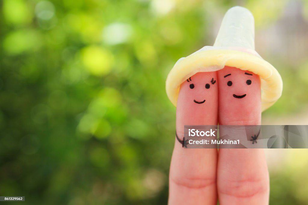 Fingers art of Happy couple. Concept of safe sex. Condom Stock Photo