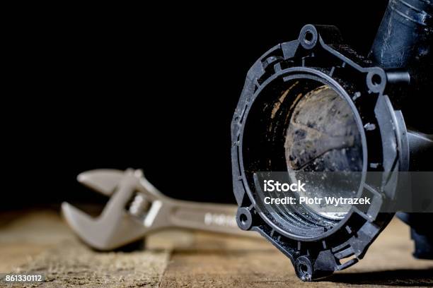 Hydraulics Tools For Plumber On Wooden Table Workshop Table And Tools Adjustable Spanner Connectors Keys Black Background Stock Photo - Download Image Now