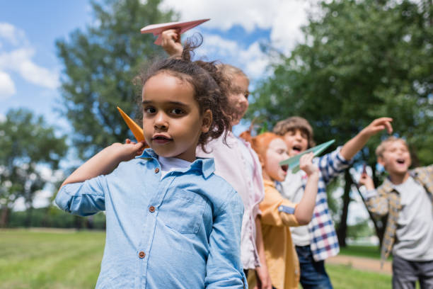 istock kids playing with paper planes 861332574