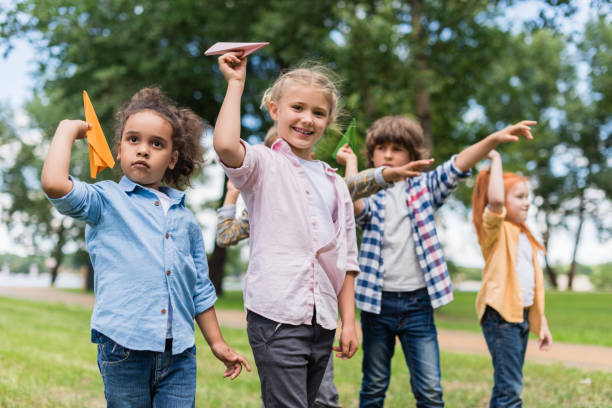 kids playing with paper planes