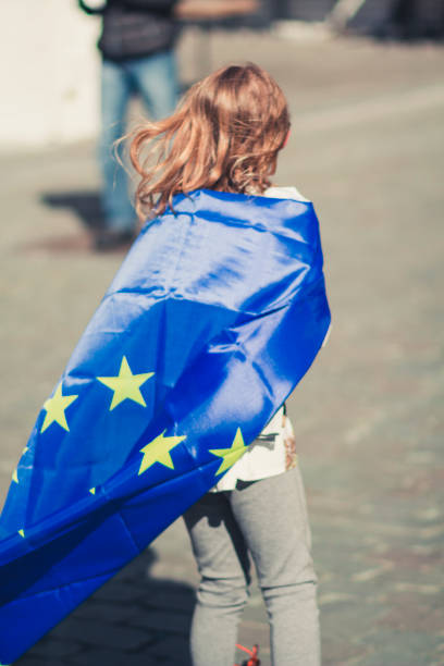 blonde 10 year old with EU flag and inline skates stock photo