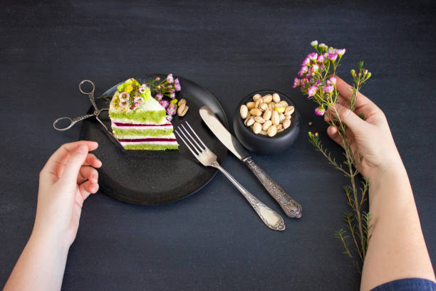 A piece of the cake with raspberry filling and pistachios