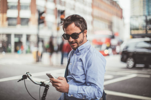 istock Man in blue shirt texting on the street 861357374