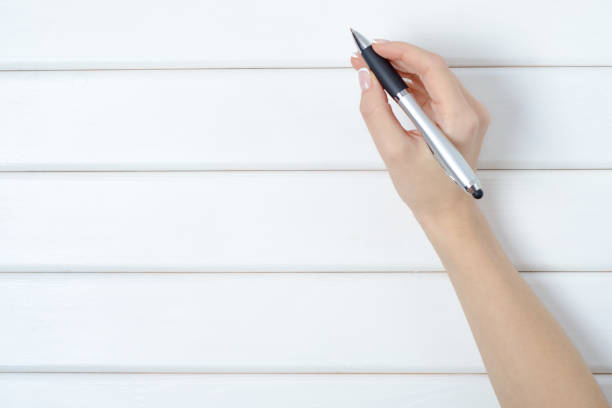 istock Female hand holding a pen 861357460