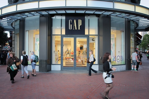 San Francisco: Shoppers walk by Gap fashion store in San Francisco, USA. Fashion retailer Gap exists since 1969 and has 3,076 stores worldwide.