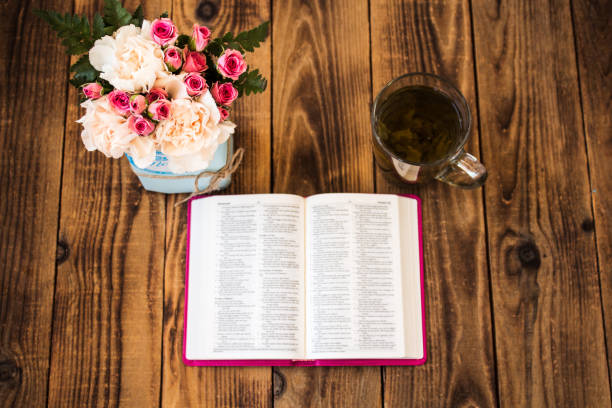 istock roses tea and bible on wooden background 861360476