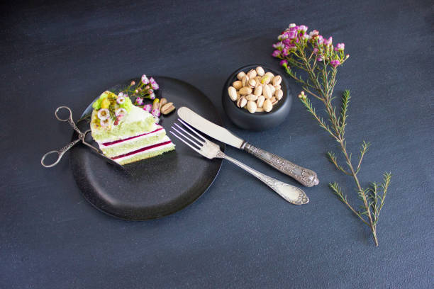 A piece of the cake with raspberry filling and pistachios