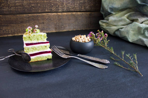 A piece of the cake with raspberry filling and pistachios