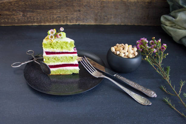 A piece of the cake with raspberry filling and pistachios