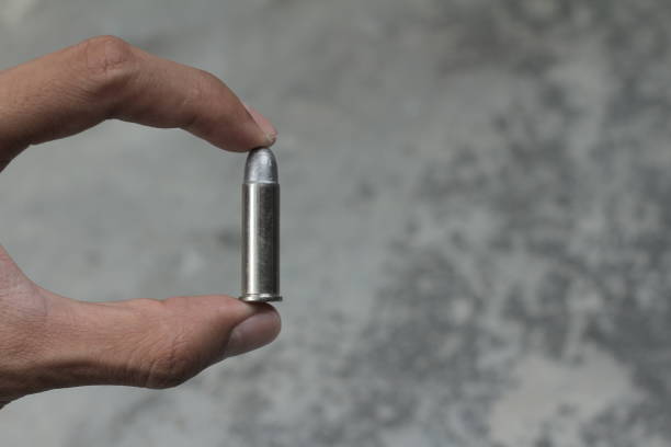 hold a bullet revolver  with with fingers