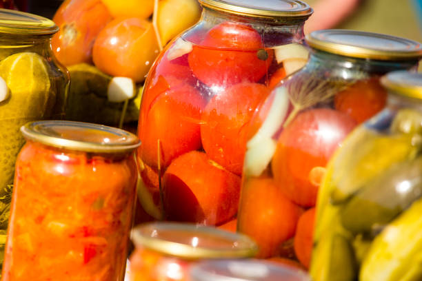 istock canned cucumbers and tomatoes in glass jars 861363598