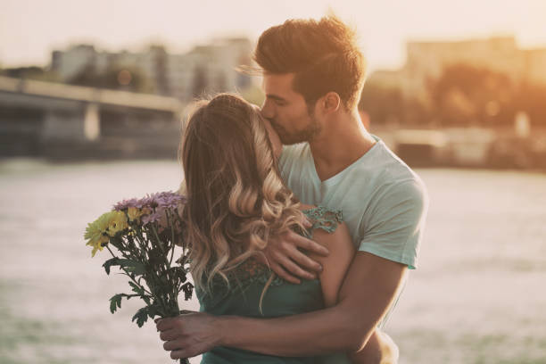 istock Man giving flowers to girlfriend 861369100