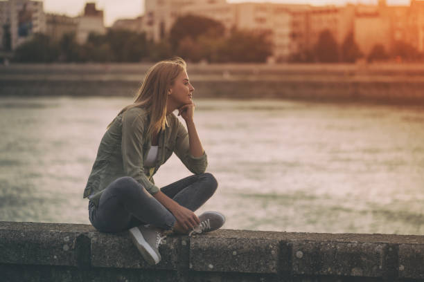 istock Woman  sitting  at the riverbank 861382964