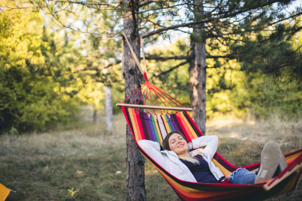 istock Young woman relaxing in a hammock 861387470