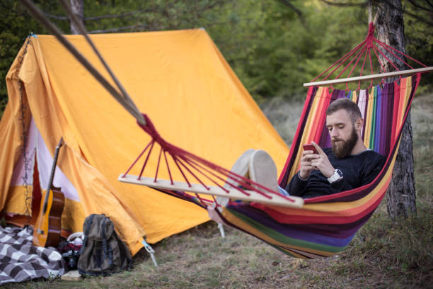 istock Relaxed man and lying in a comfortable hammock during camping 861388584