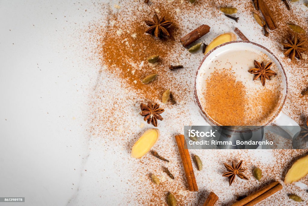 Traditional indian masala chai tea Traditional indian masala chai tea with spices - cinnamon, cardamom, anise, white background. Top view copy space Masala Stock Photo