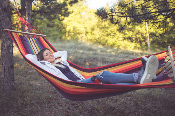 istock Young woman relaxing in a hammock 861408502