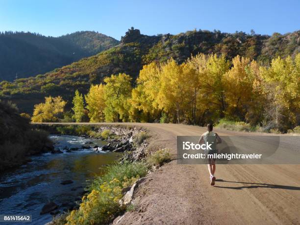 Woman Runs South Platte River Waterton Canyon Colorado Fall Colors Rocky Mountains Stock Photo - Download Image Now