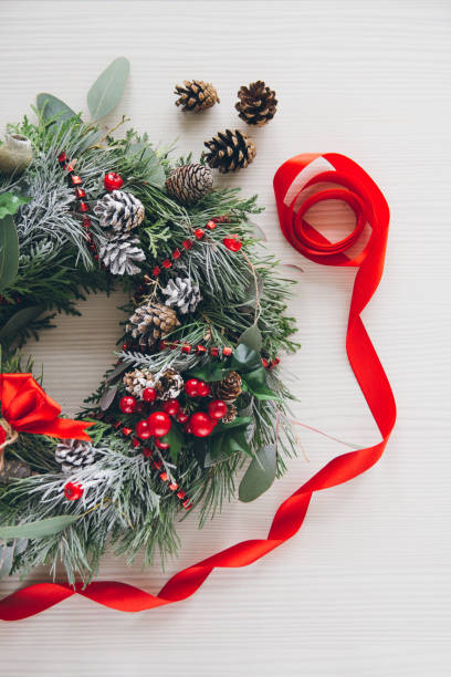 istock Homemade Christmas wreath on white wooden table 861427568