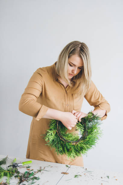 istock Florist decorator making Christmas wreath 861434966