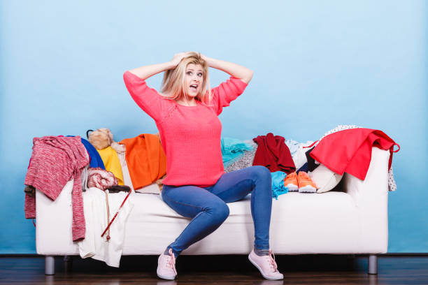 istock Woman does not know what to wear sitting on couch 861440124
