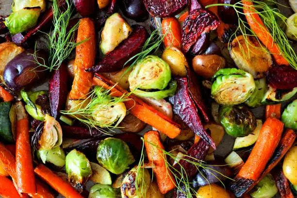 Full background of colorful roasted autumn vegetables, above view