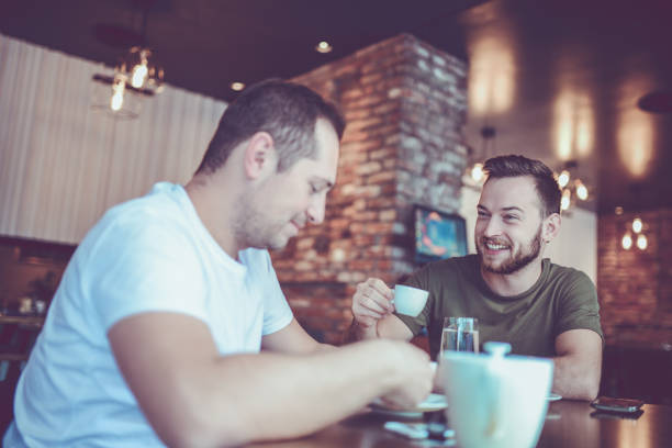 istock Two Smiling Friends Drinking Coffee and Socialising in a Cafe 861456182