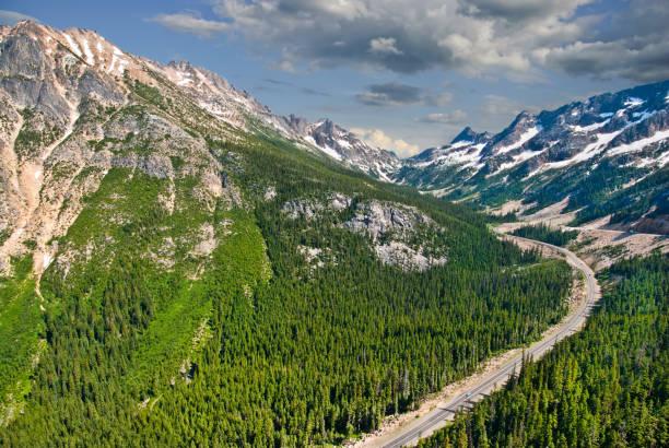 North Cascades Highway from Washington Pass The North Cascades Highway traverses the Cascade Range of mountains in an east-west direction. Only open late spring through fall, this highway offers stunning views and access into the North Cascades National Park. This winding highway scene was taken from the Washington Pass Overlook in the Okanogan National Forest, Washington State, USA. jeff goulden mountain stock pictures, royalty-free photos & images