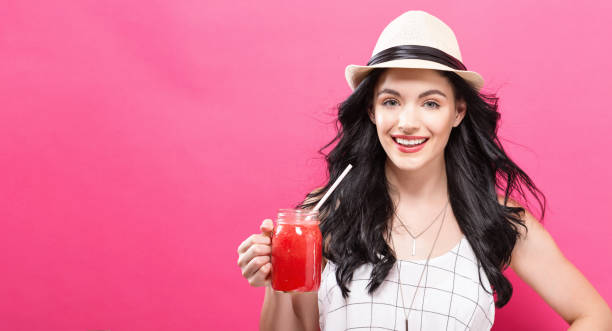 istock Happy young woman drinking smoothie 861467448