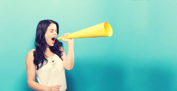 istock Young woman holding a paper megaphone 861467468