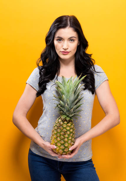 istock Happy young woman holding a pineapple 861467562