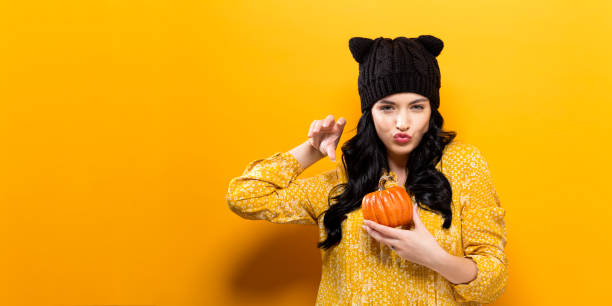 istock Young woman holding a pumpkin 861467570