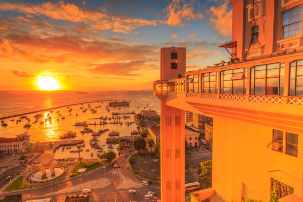 Sunset in Lacerda's Elevator in Salvador, Bahia. A wide picture of the sunset in the Lacerda's Lift at Bahia, Brazil, taken in a bright and beautiful day. The first popular elevator in Brazil. Colorful and satured taken with a Canon 6D. lacerda elevator stock pictures, royalty-free photos & images