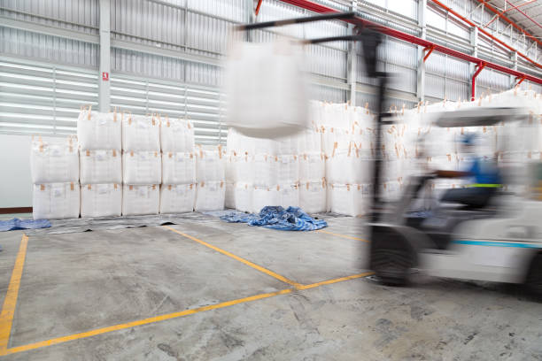 istock Warehousing. Forklift driver stacking big bag of raw material in warehouse. 861470802