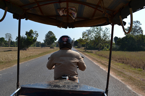 A tricycle driver carrying some tourists around Angkor Wat and Siem Reap. Pic was taken in January 2015.