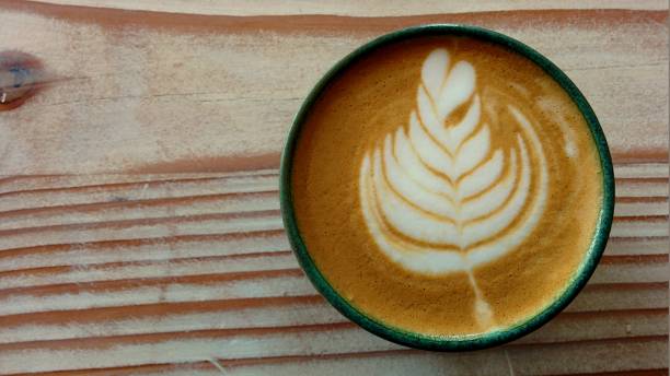 Close-up latte art on wood table