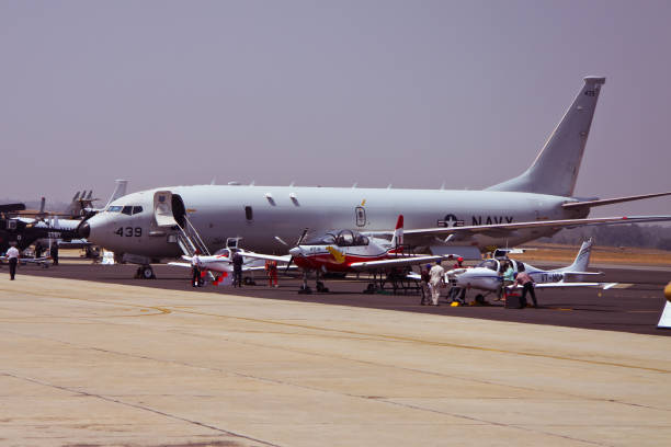Bangalore, KT, India - 02/16/2017 : Taken this picture at Aero India 2017 in Bengaluru in India of USAF P-8 on static display in front of thousands of spectators. Also in front are smaller airplane on display and most of them are propeller.