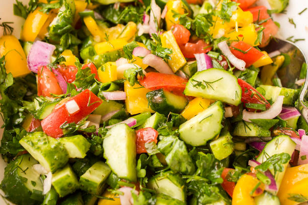 istock A fresh vegetable salad. Cucumber, tomato, onion, pepper, butter, greens 861486932