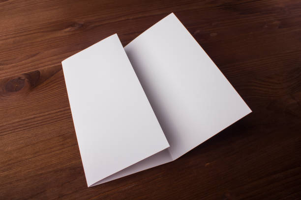 istock Blank tri fold brochure on wooden background to replace your design or message 861490110