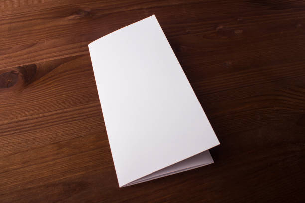 istock Blank tri fold brochure on wooden background to replace your design or message 861490112