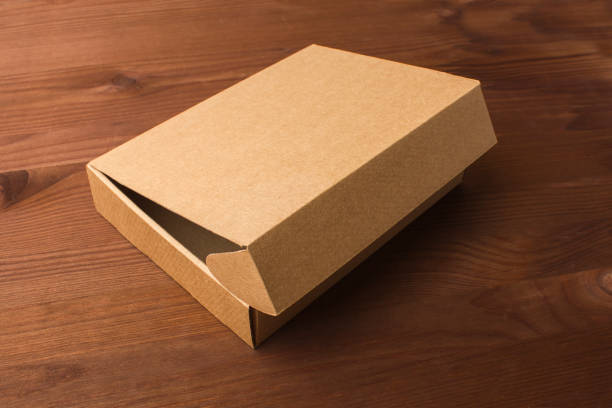 istock Cardboard box on a dark, wooden background 861490194