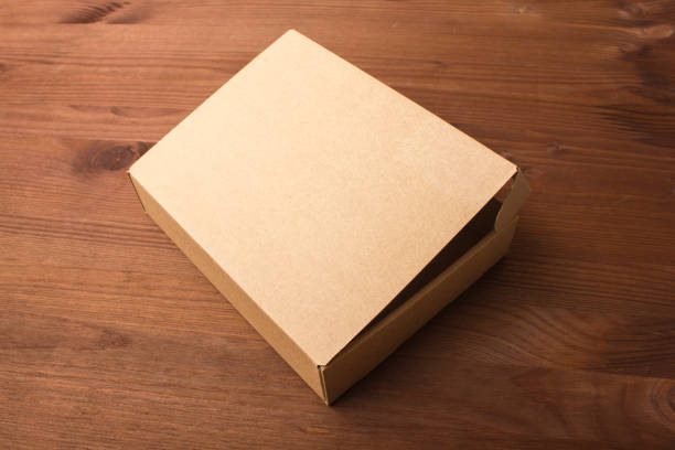 istock Cardboard box on a dark, wooden background 861490198