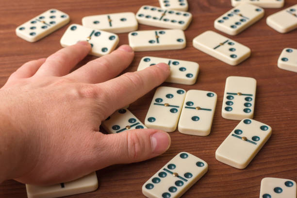 istock Dominoes on a wooden table. The game is tabletop 861493116